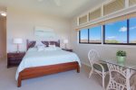 Master bedroom features wrap-around windows with island and ocean views